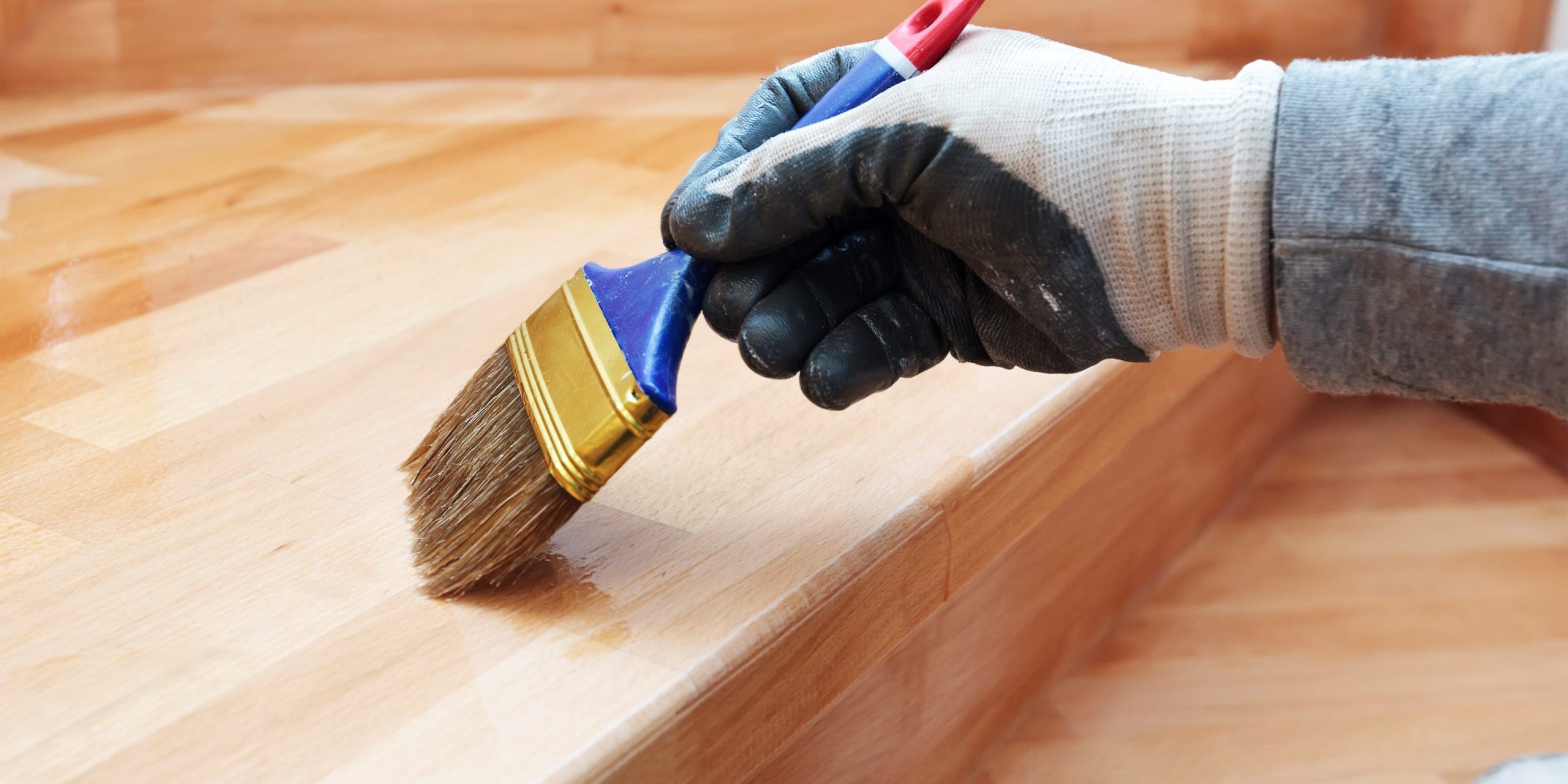 pintor-pinta-tabla-madera-barnizada-pincel